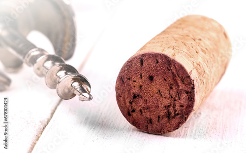 Bild auf Leinwand Wine cork and corkscrew on white surface on soft sunlight