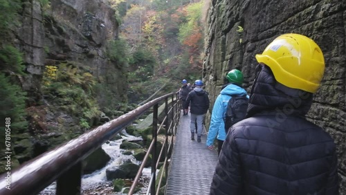 A group of tourists walks through a mountain canyon. Travel concept photo