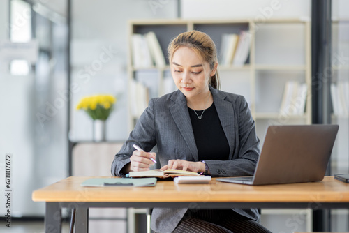 Business asian woman working at office with documents on his desk, doing planning analyzing the financial report, business plan investment, finance analysis concept