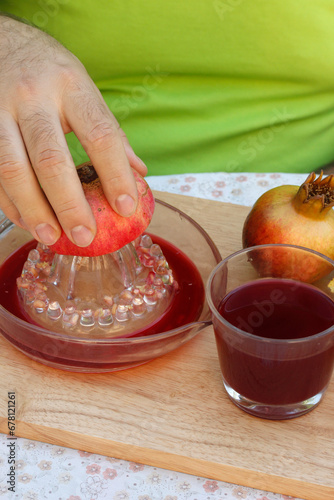 Preparing pomegranate juice. photo