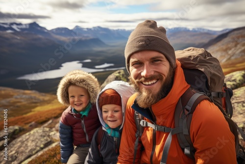 A man stands with two children on a beautiful mountain. Perfect for family adventure or outdoor activities.