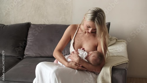 Mom breastfeeds her newborn baby.