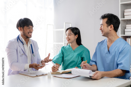 Doctor discussing diagnosis during the meeting. Group of doctor discussing work matter in the office at work. The medical team discusses treatment options with the patient.