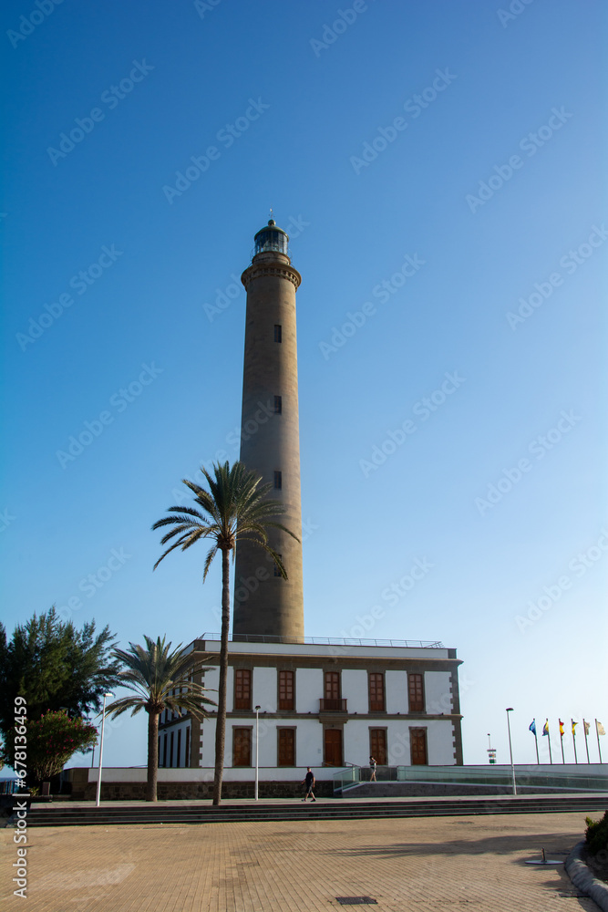 Lighthouse in Maspalomas, Gran Canaria, Spain with palm tree