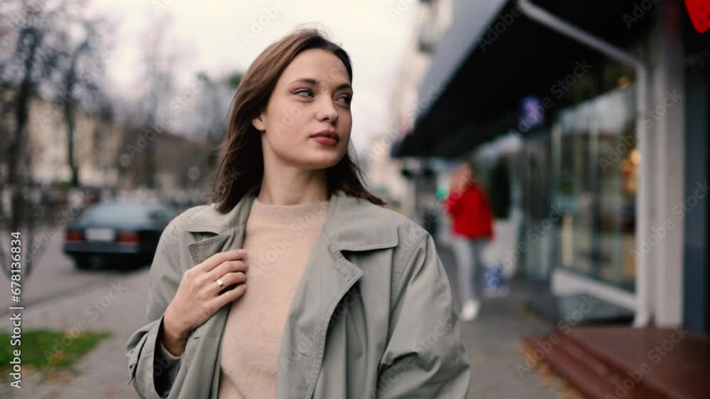 beautiful woman walks through the city in a black coat, city life of a woman. beautiful woman walks through the city in a black coat, city life of a woman.