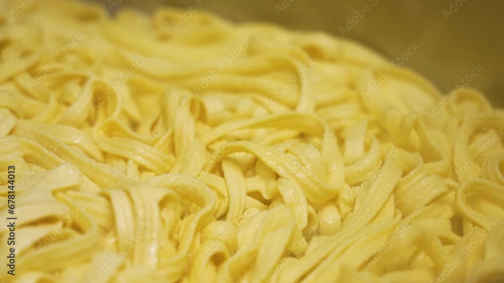 Stirring Spaetzle Noodle In a Big Pot. Close Up of Spongy Texture Egg Noodle Stirring Spaetzle Noodle In a Big Pot. Close Up of Spongy Texture Egg Noodle