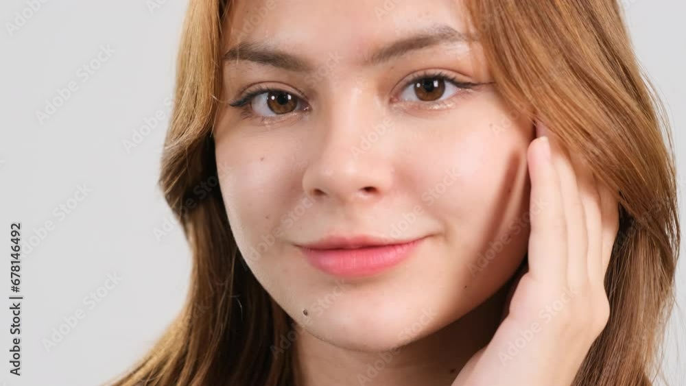 Beauty portrait of young woman touching her smooth skin in face area. Skin care make-up concept Beauty portrait of young woman touching her smooth skin in face area. Skin care make-up concept