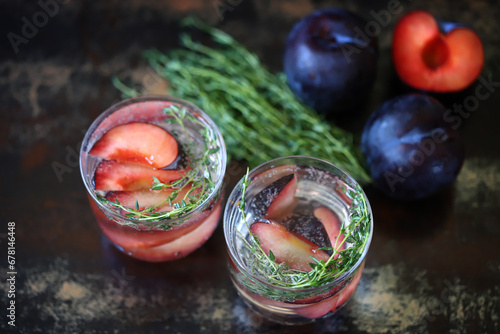 Detox drink with mineral water, plums and thyme.