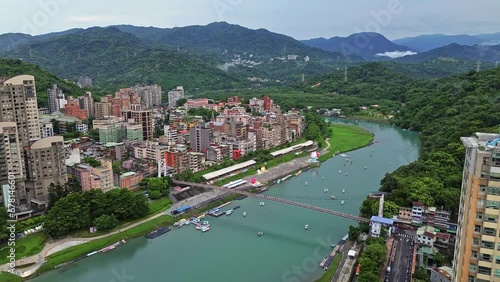 Aerial 4k footage of Bitan in Taipei, Taiwan. It is a popular spot to relax and ride boats along the river. photo