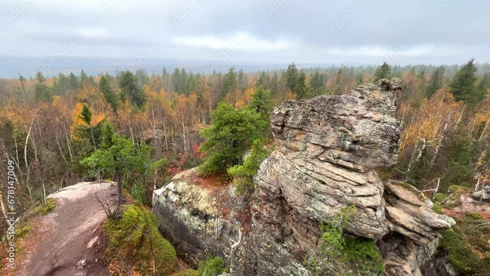 Stone City in autumn. Bright foliage and autumn landscape. The natural landscape is a rock formation in Central Russia, the Urals. A natural monument. Ancient rocky folding in the Ural Mountains. 4K Stone City in autumn. Bright foliage and autumn landscape. The natural landscape is a rock formation in Central Russia, the Urals. A natural monument. Ancient rocky folding in the Ural Mountains. 4K