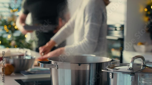 Wallpaper Mural Selective focus of caucasian couple preparing food before Christmas. Shot with RED helium camera in 8K.   Torontodigital.ca