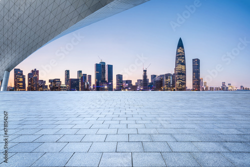 City square and skyline with modern buildings in Shenzhen at sunset  Guangdong Province  China. Empty square floor and city building background.