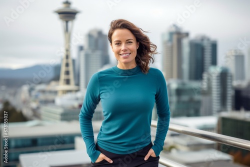 Portrait of a blissful woman in her 30s showing off a thermal merino wool top against a vibrant city skyline. AI Generation