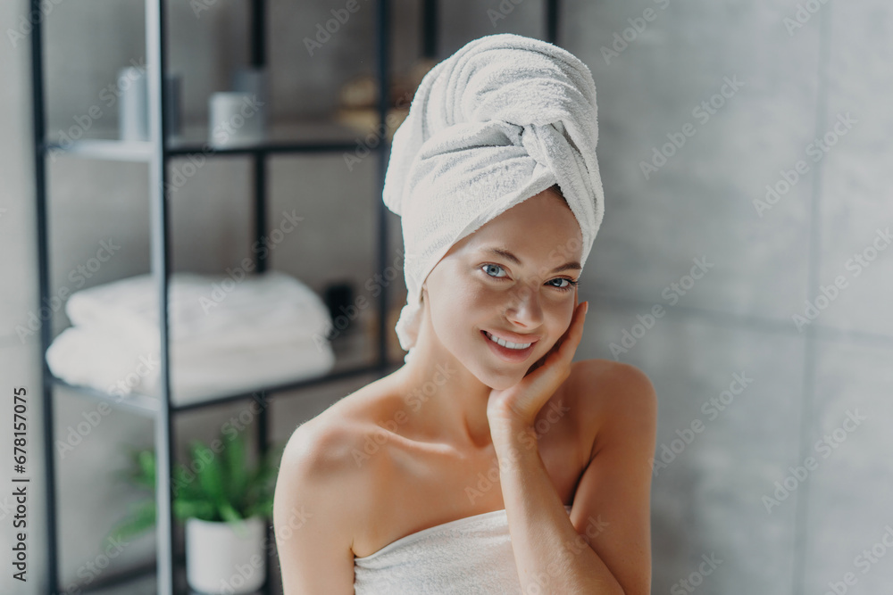 A serene woman in a spa with a towel on her head, exuding tranquility and wellness A serene woman in a spa with a towel on her head, exuding tranquility and wellness