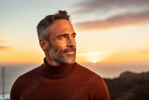 Portrait of a satisfied man in his 40s wearing a classic turtleneck sweater against a vibrant sunset horizon. AI Generation