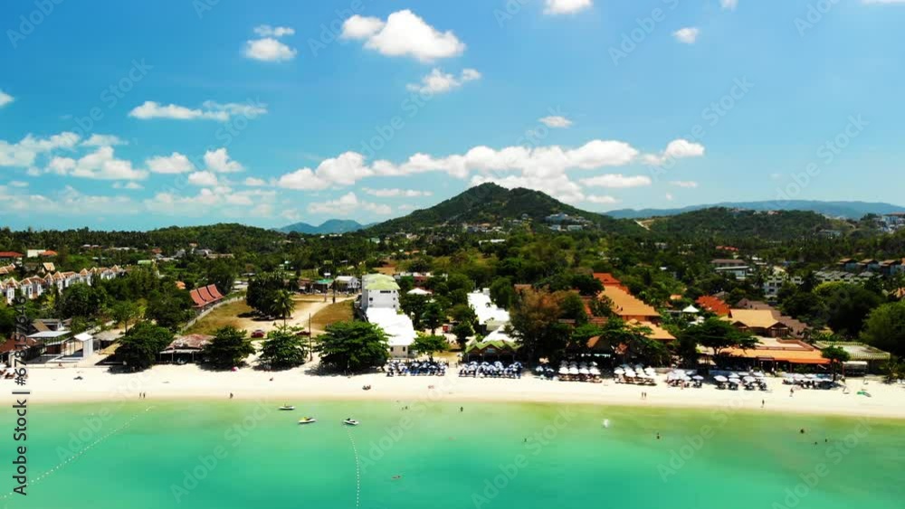 Hovering and slowly tilting while doing an aerial drone shot of Choeng Mon beach in Koh Samui island off the coast of Surat Thani province in Thailand. Hovering and slowly tilting while doing an aerial drone shot of Choeng Mon beach in Koh Samui island off the coast of Surat Thani province in Thailand.