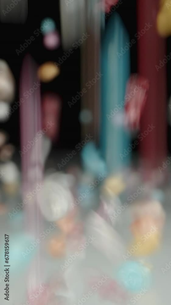 Vertical video. On the White Glass Table, Colorful Sugar is Sprinkled, Bright Crystals Forming a Sweet Pile. Dolly slider close-up. Slow motion Vertical video. On the White Glass Table, Colorful Sugar is Sprinkled, Bright Crystals Forming a Sweet Pile. Dolly slider close-up. Slow motion