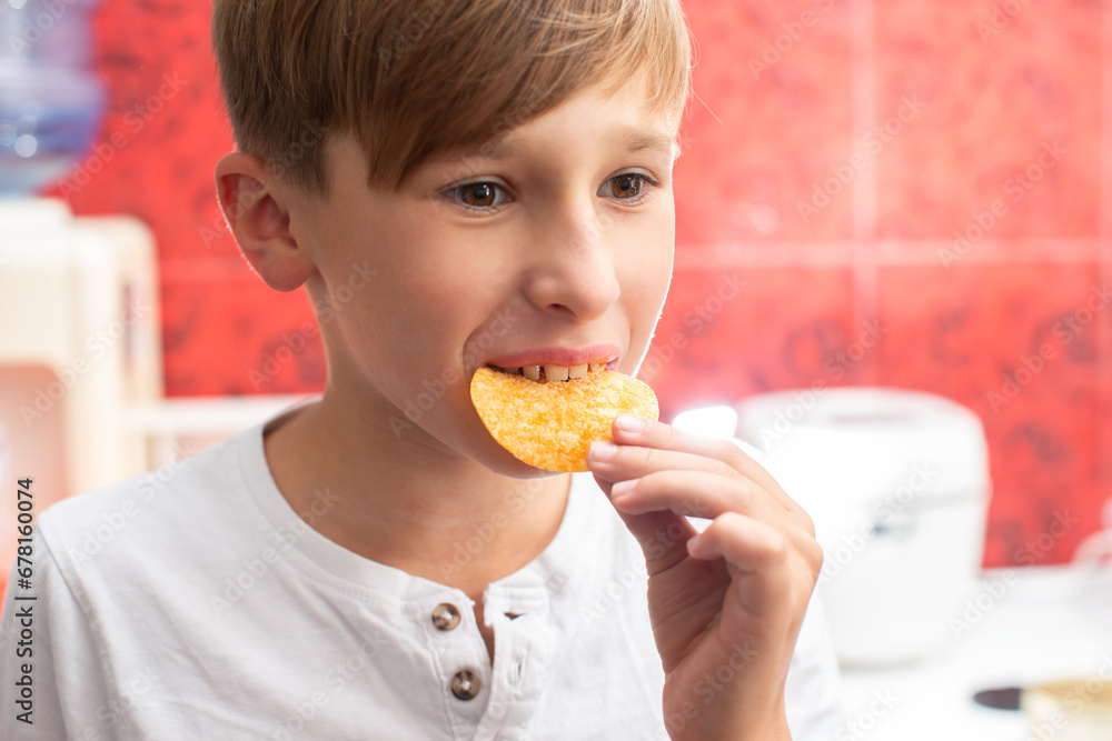 Boy eating chips close-up. Potato chip child. Boy eating chips close-up. Potato chip child.