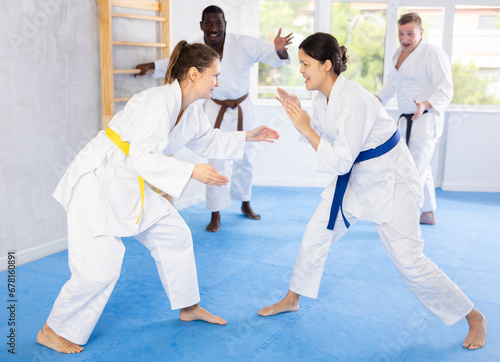 Two female athletes playing Judo in sport hall