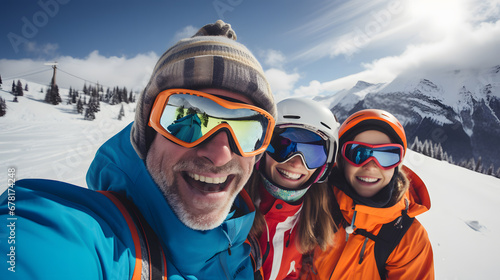 Happy group of skiers taking selfie sitting on winter slope