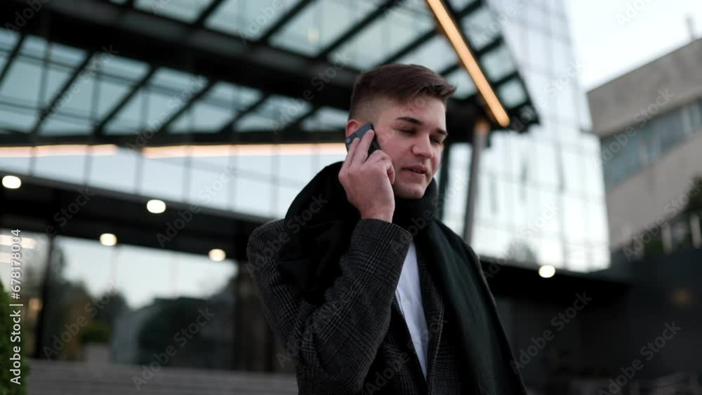 Urban professional on the move a young white-collar worker confidently using his smartphone, showcasing the blend of technology and business acumen in the cityscape. Urban professional on the move a young white-collar worker confidently using his smartphone, showcasing the blend of technology and business acumen in the cityscape.