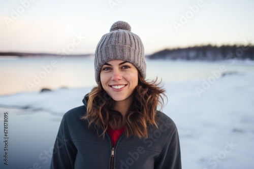 Portrait of a tender woman in her 40s sporting a trendy beanie against a backdrop of a frozen winter lake. AI Generation