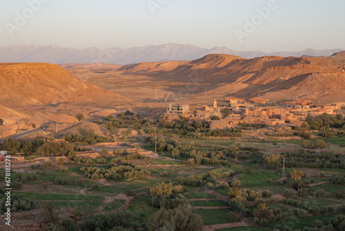Village in the green fertile riverbed of the Draa river in the Sahara Desert with typical architecture