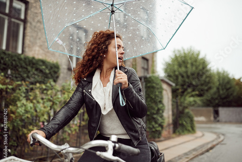 Woman commuting in the rain on her bike photo