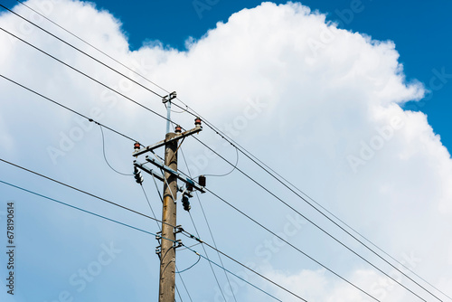 View of Telephone poles with blue sky and white clouds as a background photo