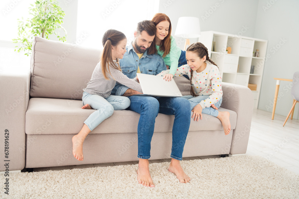 Full size photo of four people handsome guy cheerful carefree girls sit on couch hands closing laptop weekend indoors Full size photo of four people handsome guy cheerful carefree girls sit on couch hands closing laptop weekend indoors