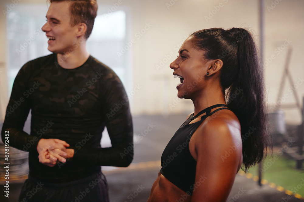 Fit young woman laughing with a friend at the gym Fit young woman laughing with a friend at the gym