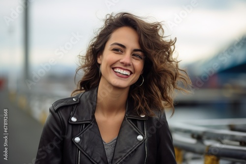Portrait of a cheerful woman in her 30s sporting a classic leather jacket against a modern cityscape background. AI Generation