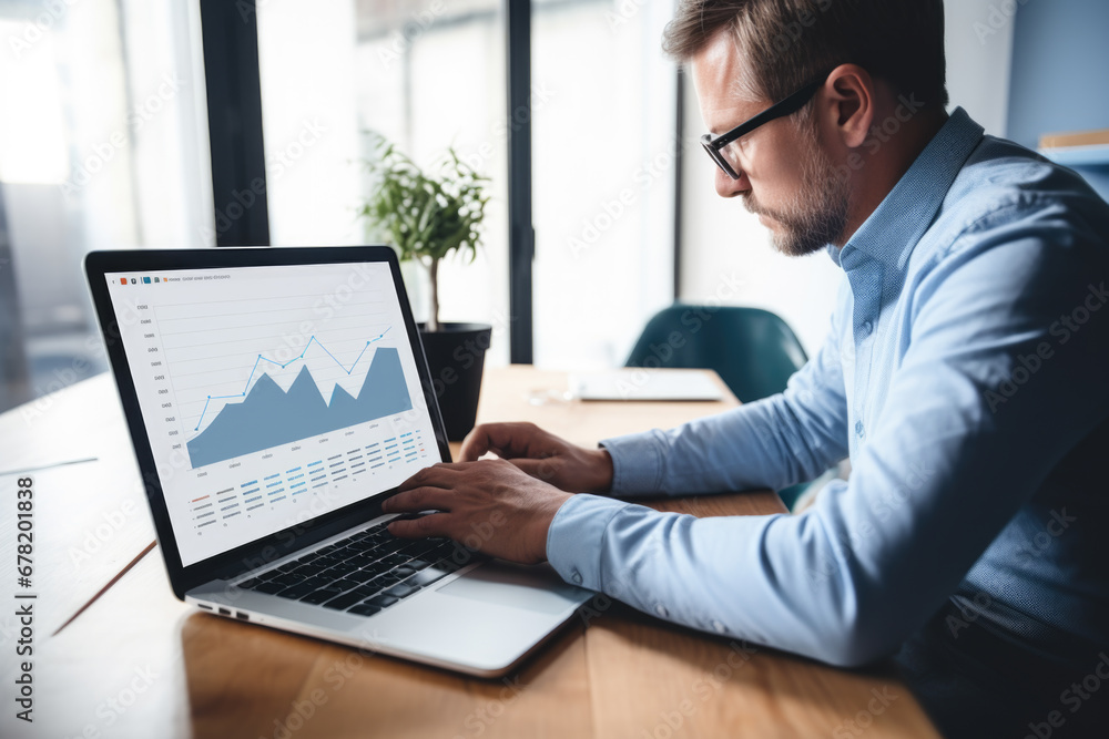 Man sitting at home office with laptop and working with growing graph. Business data analytics concept Man sitting at home office with laptop and working with growing graph. Business data analytics concept