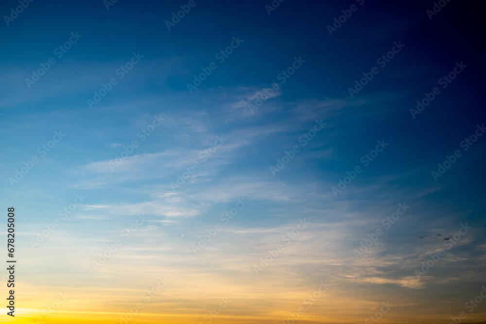 Fototapeta premium Real amazing Beautiful sunrise and luxury soft gradient orange gold clouds with sunlight on the blue sky perfect for the background, take in everning, Twilight sunset sky with gentle colorful clouds
