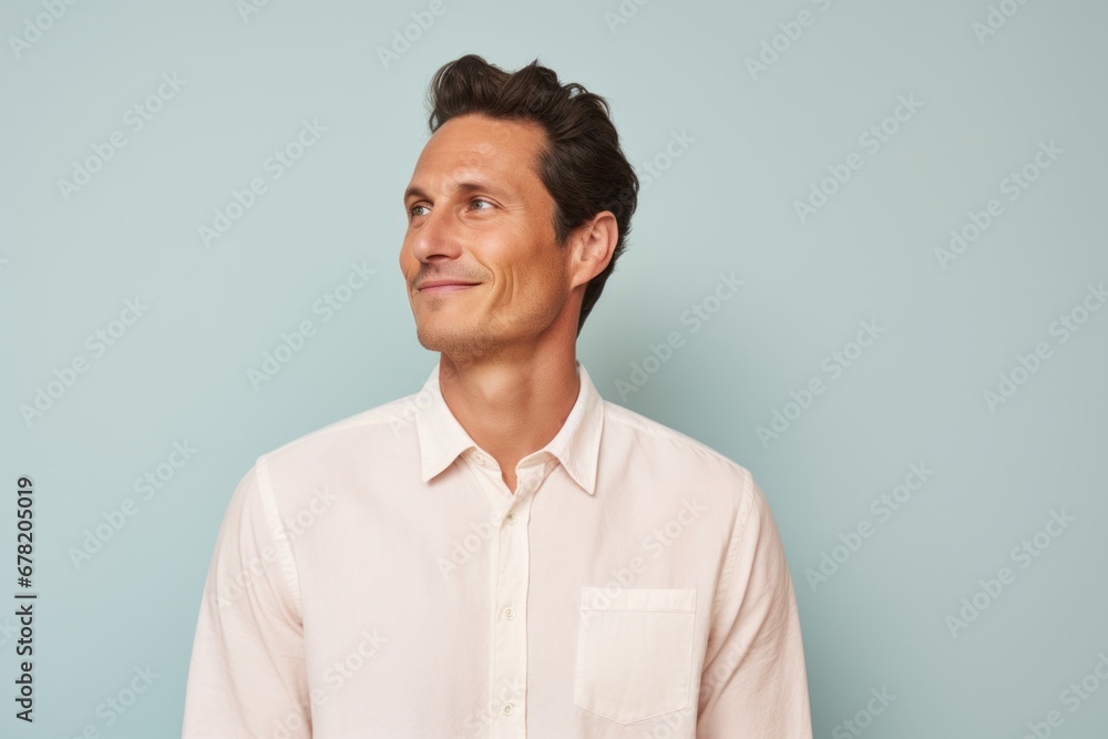 Portrait of a blissful man in his 30s wearing a simple cotton shirt against a pastel or soft colors background. AI Generation Portrait of a blissful man in his 30s wearing a simple cotton shirt against a pastel or soft colors background. AI Generation