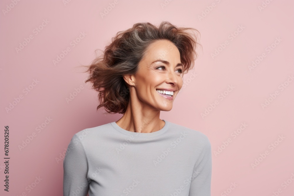 Portrait of a happy woman in her 40s showing off a thermal merino wool top against a pastel or soft colors background. AI Generation Portrait of a happy woman in her 40s showing off a thermal merino wool top against a pastel or soft colors background. AI Generation