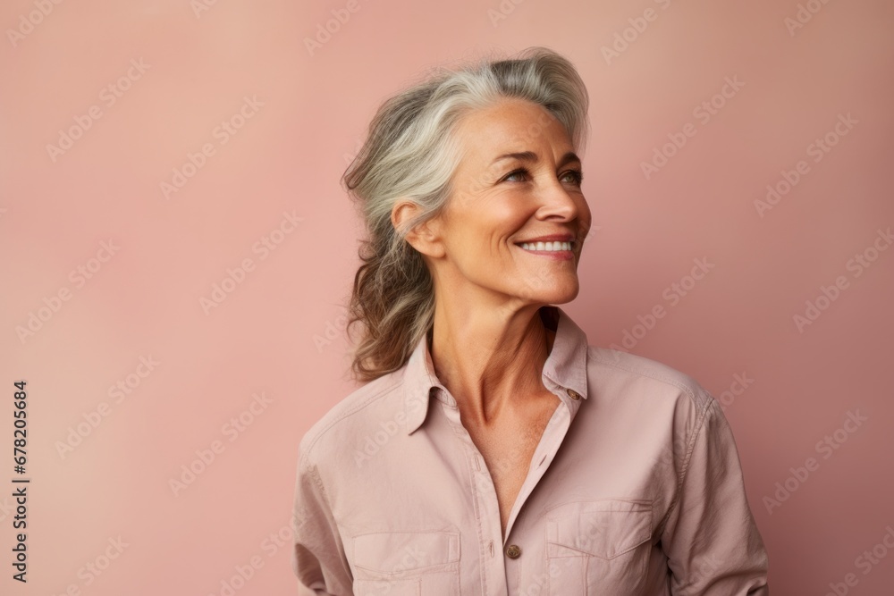 Portrait of a tender woman in her 50s sporting a breathable hiking shirt against a pastel or soft colors background. AI Generation Portrait of a tender woman in her 50s sporting a breathable hiking shirt against a pastel or soft colors background. AI Generation