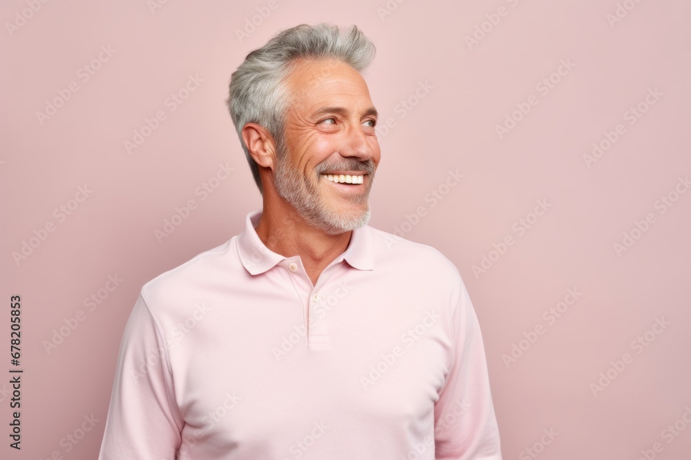 Portrait of a tender man in his 50s donning a classy polo shirt against a pastel or soft colors background. AI Generation Portrait of a tender man in his 50s donning a classy polo shirt against a pastel or soft colors background. AI Generation
