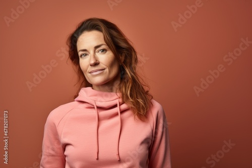 Portrait of a content woman in her 30s wearing a thermal fleece pullover against a solid color backdrop. AI Generation © CogniLens