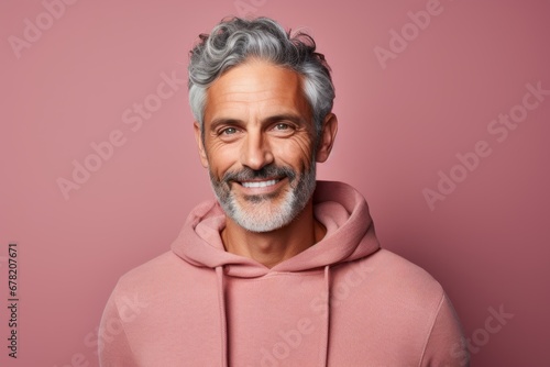 Portrait of a glad man in his 50s dressed in a comfy fleece pullover against a solid color backdrop. AI Generation