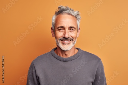 Portrait of a glad man in his 50s dressed in a comfy fleece pullover against a solid color backdrop. AI Generation
