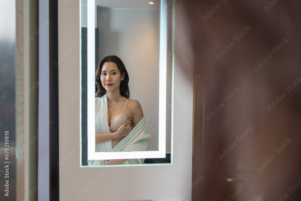 Breast cancer, World Cancer Day, Asian woman doing self-examination for a lump or cancer in her breast by using her hand to feel for a lump in the area of her breast. Breast cancer, World Cancer Day, Asian woman doing self-examination for a lump or cancer in her breast by using her hand to feel for a lump in the area of her breast.