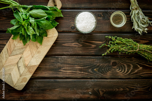 Fototapeta Naklejka Na Ścianę i Meble -  Bunches of fresh spicy herbs on wooden board for cooking, top view