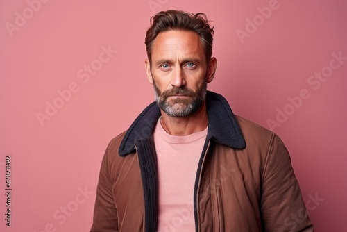 Portrait of a tender man in his 40s dressed in a warm wool sweater against a solid pastel color wall. AI Generation