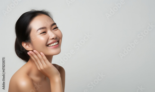 Radiant Beauty, Smiling Woman Caresses Her Flawless Face with Elegance