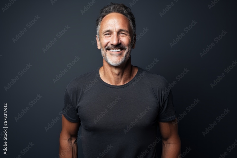 Portrait of a smiling man in his 50s dressed in a casual t-shirt against a bare monochromatic room. AI Generation Portrait of a smiling man in his 50s dressed in a casual t-shirt against a bare monochromatic room. AI Generation