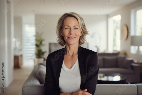 Portrait of a happy woman in her 40s dressed in a polished vest against a crisp minimalistic living room. AI Generation