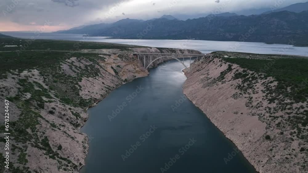 Aerial panoramic video with Maslenica bridge - a deck arch bridge near town of Zadar in Croatia with beautiful clouds over Adriatic sea