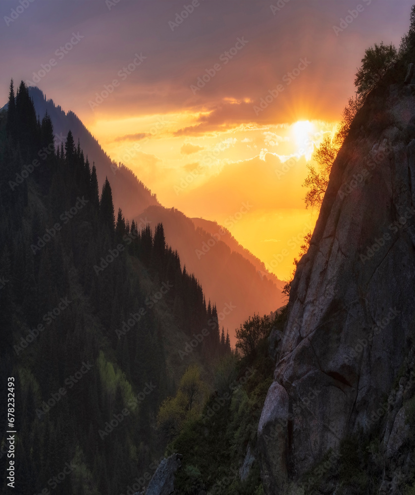 Golden sunset and sun in the mountains with forest. Beautiful mountain landscape. Tien Shan Mountains in Kazakhstan