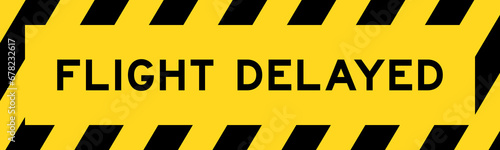Yellow and black color with line striped label banner with word flight delayed